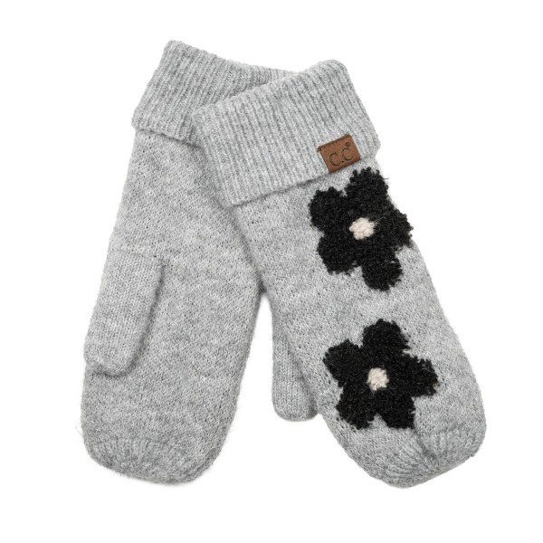 Heathered knit mittens with raised daisy appliques across the back of the hand and a ribbed fold over cuff. The soft, textured knit traps warmth and feels cozy on frosty walks, holiday markets, and school runs. Playful flower details bring a cheerful, retro feel to a practical cold weather basic. A fun gift pick that pairs perfectly with beanies and scarves and sells well in multiples.