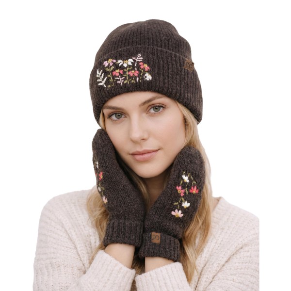 Knit mittens with a delicate embroidered wildflower sprig on the back of the hand and a ribbed fold over cuff. The soft, warm knit keeps hands cozy on chilly walks, holiday shopping trips, and school pickup lines. A dainty floral detail gives a classic winter staple a fresh, feminine touch. An easy gift item that pairs beautifully with beanies and scarves in a cold weather display.