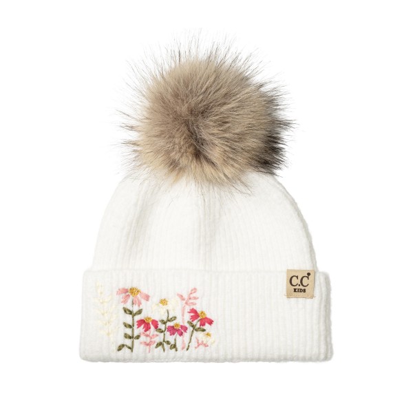 Kids knit pom beanie with delicate embroidered flowers on a fold over cuff and a fluffy faux fur pom on top. The soft ribbed knit stretches for a comfortable fit and keeps little ears warm on cold school mornings and weekend outings. A sweet, feminine design that parents love for holiday photos and gifting. Floral kids beanies sell fast as stocking stuffers and pair perfectly with matching mittens.
