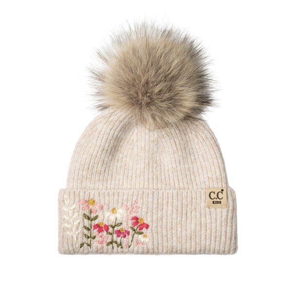 Kids knit pom beanie with delicate embroidered flowers on a fold over cuff and a fluffy faux fur pom on top. The soft ribbed knit stretches for a comfortable fit and keeps little ears warm on cold school mornings and weekend outings. A sweet, feminine design that parents love for holiday photos and gifting. Floral kids beanies sell fast as stocking stuffers and pair perfectly with matching mittens.