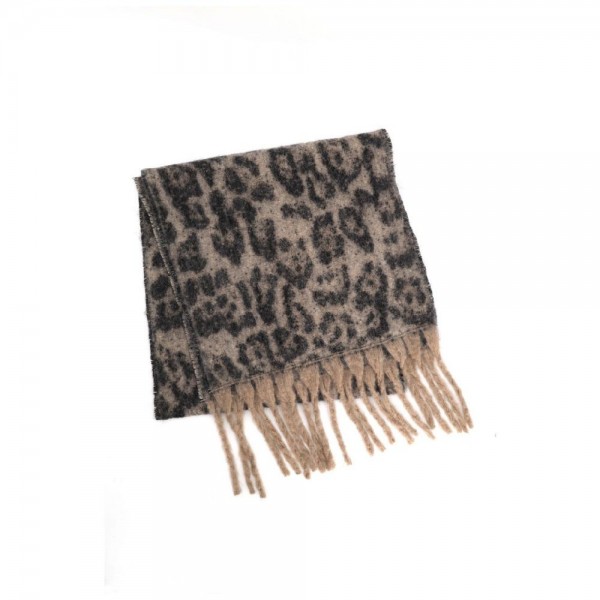 Animal print scarf in a soft brushed knit with long knotted fringe on both ends. Generous wrap length loops twice at the neck or drapes open over a coat, and the spotted print does the styling on its own. A cold weather staple for boutique buyers stocking travel, tailgates, farmers markets, and holiday gifting. Animal print scarves are a proven repeat seller that never sits on the rack.