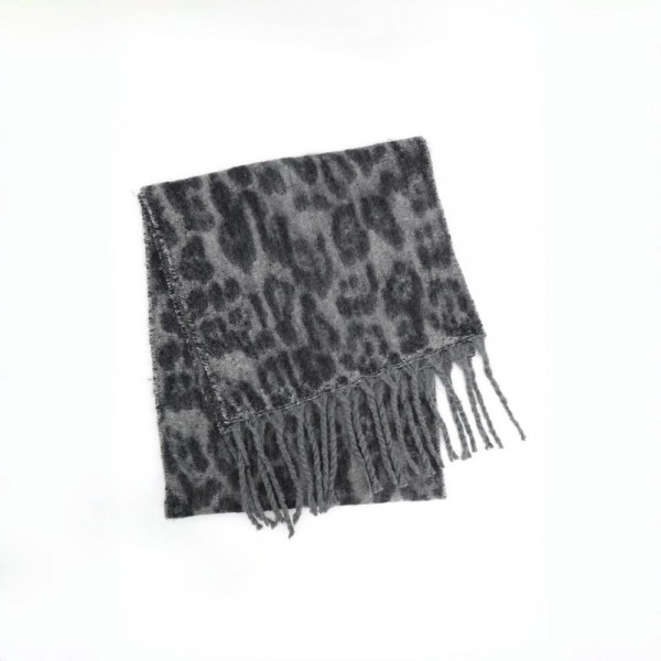 Animal print scarf in a soft brushed knit with long knotted fringe on both ends. Generous wrap length loops twice at the neck or drapes open over a coat, and the spotted print does the styling on its own. A cold weather staple for boutique buyers stocking travel, tailgates, farmers markets, and holiday gifting. Animal print scarves are a proven repeat seller that never sits on the rack.