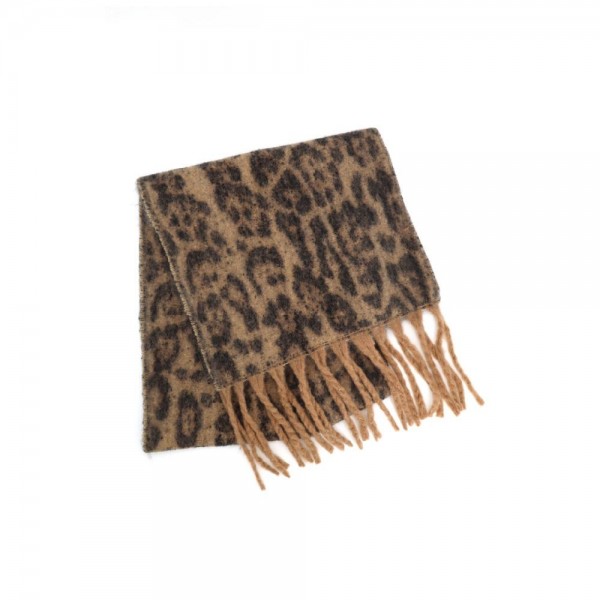 Animal print scarf in a soft brushed knit with long knotted fringe on both ends. Generous wrap length loops twice at the neck or drapes open over a coat, and the spotted print does the styling on its own. A cold weather staple for boutique buyers stocking travel, tailgates, farmers markets, and holiday gifting. Animal print scarves are a proven repeat seller that never sits on the rack.