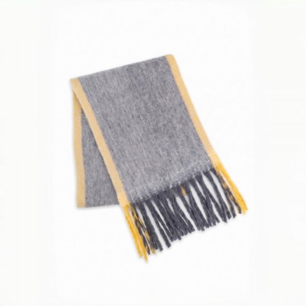 Oversized Plaid Blanket Scarf with soft brushed finish and fringed edges. Generously sized to wear looped, draped, or wrapped as a shawl, it layers beautifully over coats and sweaters for instant cold-weather polish. A fall and winter staple that anchors seasonal displays — boutique customers stock multiple patterns because these fly off the shelf as gifts and self-purchases alike.