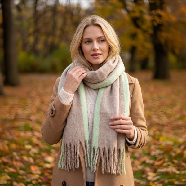 Oversized Plaid Blanket Scarf with soft brushed finish and fringed edges. Generously sized to wear looped, draped, or wrapped as a shawl, it layers beautifully over coats and sweaters for instant cold-weather polish. A fall and winter staple that anchors seasonal displays — boutique customers stock multiple patterns because these fly off the shelf as gifts and self-purchases alike.