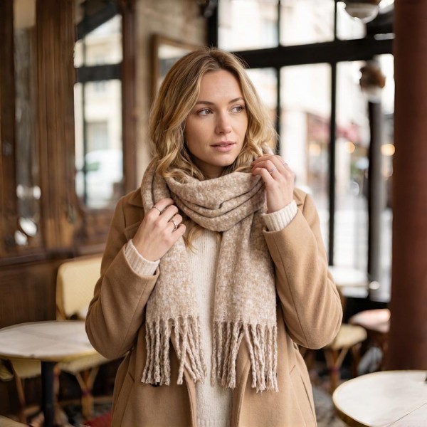 Chunky boucle knit scarf in a lofty marled yarn with long shaggy fringe. Extra wide and extra long, it wraps twice with room to spare and holds warmth without feeling heavy. A cold weather staple for boutique buyers stocking travel, tailgates, farmers markets, and holiday gifting. Oversized knit scarves fill a display fast and reorder in every shade once temperatures drop.