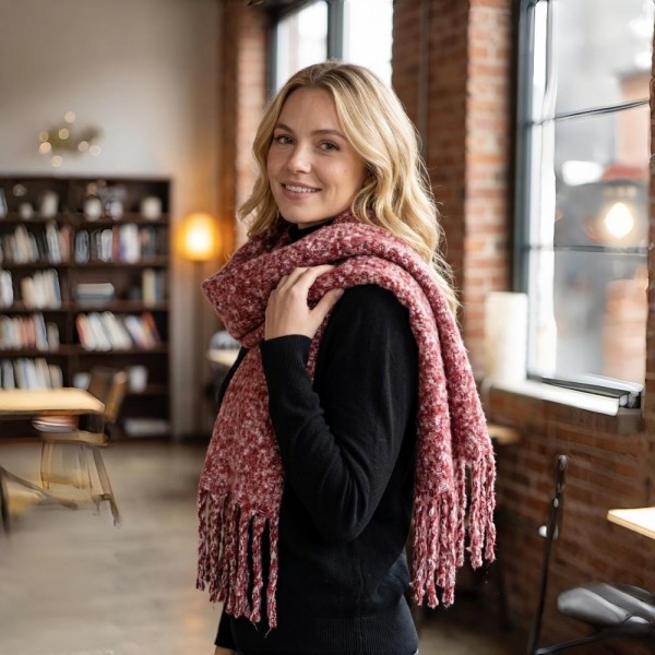 Chunky boucle knit scarf in a lofty marled yarn with long shaggy fringe. Extra wide and extra long, it wraps twice with room to spare and holds warmth without feeling heavy. A cold weather staple for boutique buyers stocking travel, tailgates, farmers markets, and holiday gifting. Oversized knit scarves fill a display fast and reorder in every shade once temperatures drop.