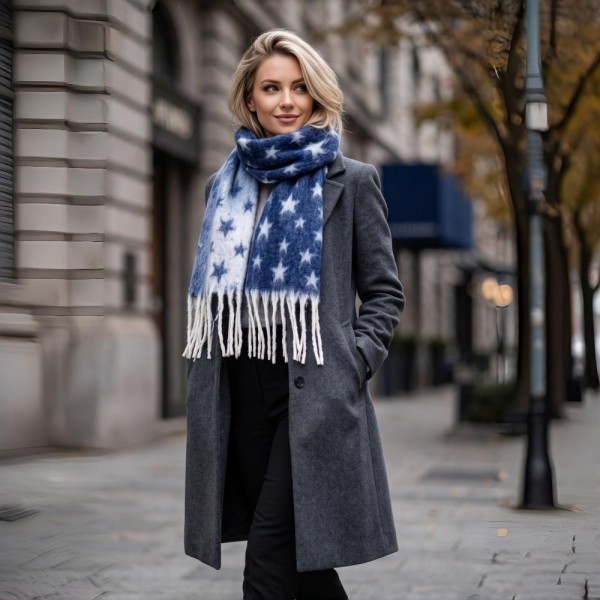 Star Print Fringe Scarf in a soft brushed woven fabric with an allover star pattern and hand knotted fringe ends. Generously sized to wrap, loop, or drape open over a coat, and light enough to keep on indoors. Star prints read festive without being locked to one holiday, so it sells from early fall straight through the new year. A dependable scarf program at a boutique friendly price point.