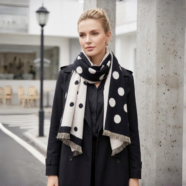 Polka dot scarf in a soft brushed weave with a reversible two tone face and knotted fringe ends. Long wrap length loops twice or hangs open over a coat, and the oversized dot pattern gives a plain outfit a finished look. A cold weather staple for boutique buyers stocking travel, tailgates, farmers markets, and holiday gifting. Printed fringe scarves are the easiest add on at the register all season long.