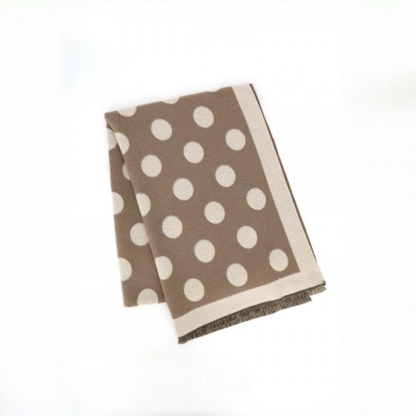 Polka dot scarf in a soft brushed weave with a reversible two tone face and knotted fringe ends. Long wrap length loops twice or hangs open over a coat, and the oversized dot pattern gives a plain outfit a finished look. A cold weather staple for boutique buyers stocking travel, tailgates, farmers markets, and holiday gifting. Printed fringe scarves are the easiest add on at the register all season long.