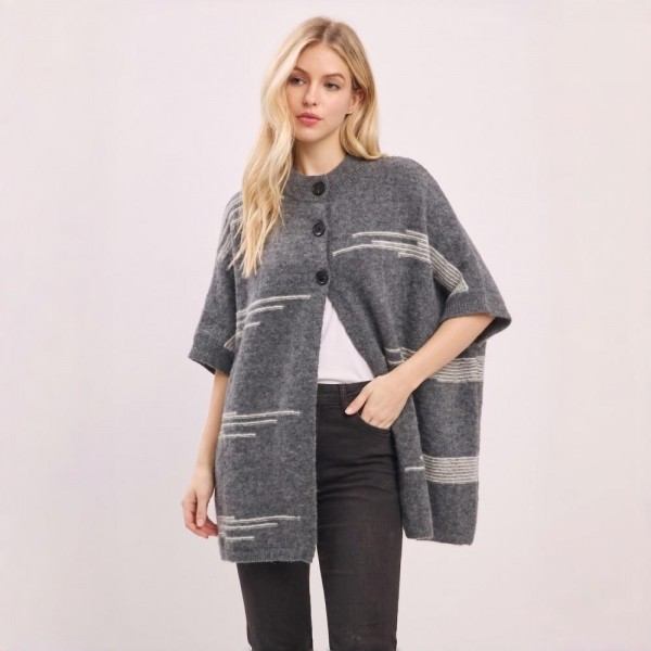Button front poncho in a brushed blanket knit with a wide contrast stripe and side pockets. One size drape falls past the hip and layers over long sleeves, denim, or leggings without adding bulk. A fall and winter layer for boutique buyers stocking travel, football weekends, church, and cold office mornings. Blanket stripe ponchos read as the statement layer on a mannequin and sell through fast.