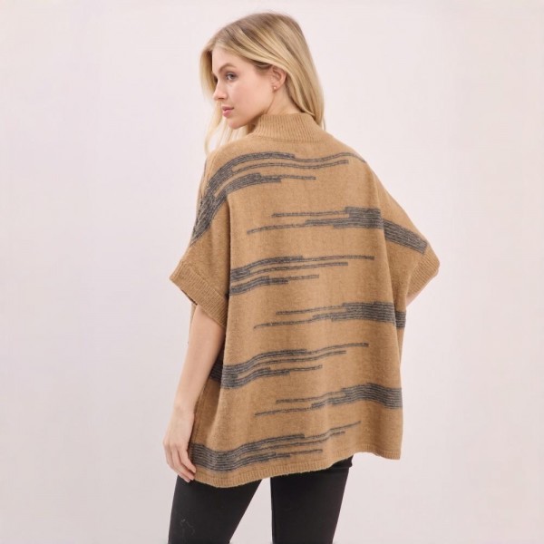 Button front poncho in a brushed blanket knit with a wide contrast stripe and side pockets. One size drape falls past the hip and layers over long sleeves, denim, or leggings without adding bulk. A fall and winter layer for boutique buyers stocking travel, football weekends, church, and cold office mornings. Blanket stripe ponchos read as the statement layer on a mannequin and sell through fast.