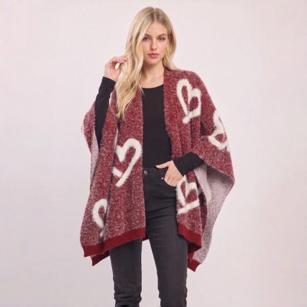 Heart Pattern Knit Ruana Poncho with an open-front silhouette and cozy oversized drape. The soft jacquard knit features an allover heart motif with contrast trim — a one-size layering piece that flatters effortlessly over leggings, denim, or dresses. A statement outerwear piece that photographs beautifully for social posts and sells fast at boutiques as the ultimate cozy gift.