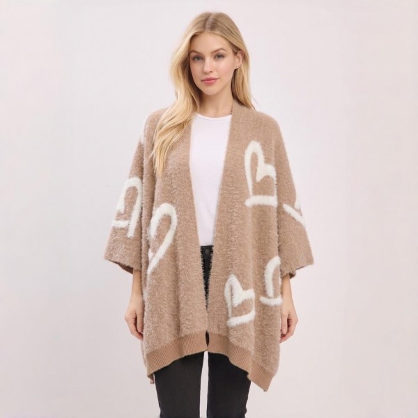 Heart Pattern Knit Ruana Poncho with an open-front silhouette and cozy oversized drape. The soft jacquard knit features an allover heart motif with contrast trim — a one-size layering piece that flatters effortlessly over leggings, denim, or dresses. A statement outerwear piece that photographs beautifully for social posts and sells fast at boutiques as the ultimate cozy gift.