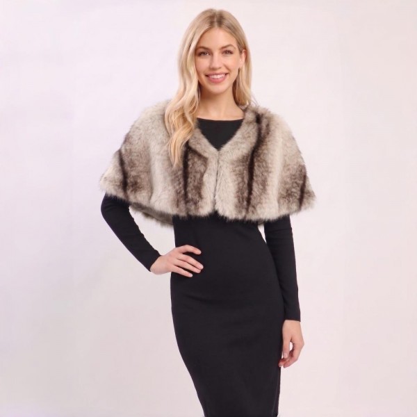 Faux Fur Capelet Shrug with plush layered texture and an elegant cropped silhouette. This shoulder-wrap style tops off dresses, evening looks, and holiday outfits with instant glamour — easy to slip on over any neckline. A dressy occasion piece that shines during holiday and event season; boutique customers snap these up for parties, weddings, and gifting.