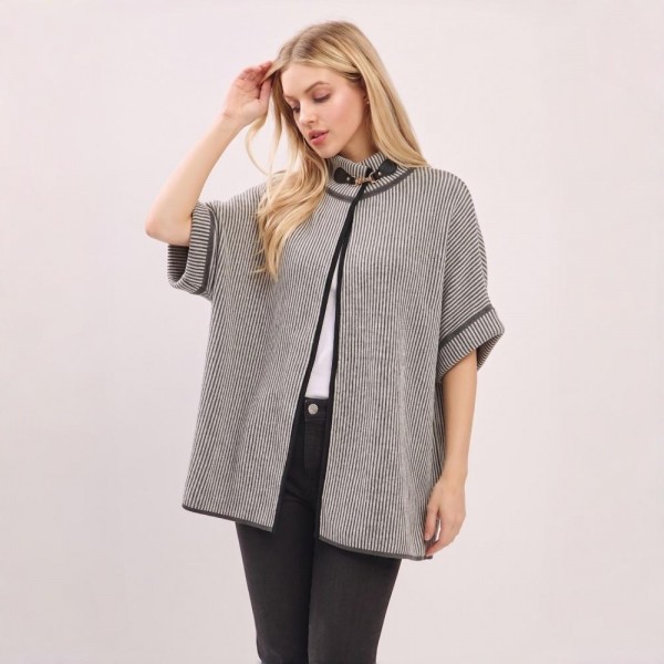 Striped knit poncho with a button front placket and a soft reversible face. One size cut drops past the hip, layers over long sleeves or a turtleneck, and keeps its shape through repeat wear. A fall and winter layer for boutique buyers stocking travel, football weekends, church, and cold office mornings. Striped ponchos are an easy mannequin piece that moves the whole outfit.