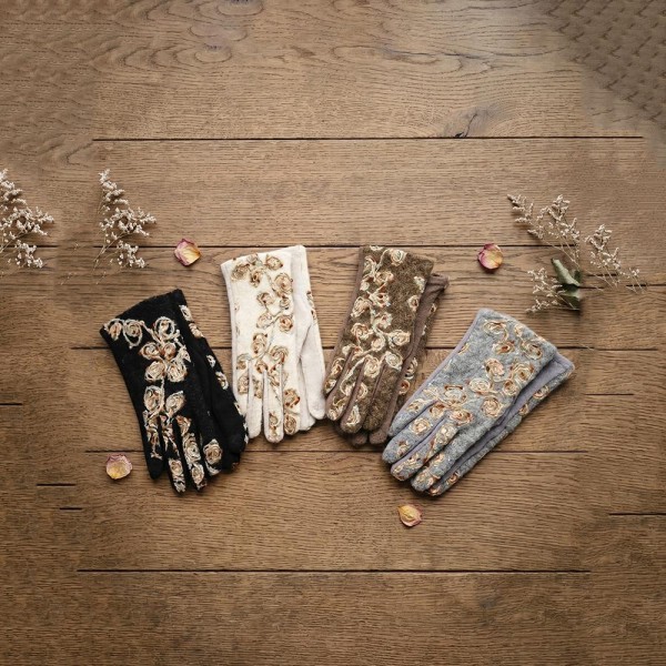Touchscreen gloves with metallic floral embroidery across a brushed knit back and a soft stretch palm. Conductive fingertips let her text and scroll without taking them off, and the slim fit dresses up a coat sleeve. A fall and winter accessory for boutique gift walls, holiday markets, church, and cold morning commutes. Embroidered texting gloves give a jewelry level gift at an easy price point.