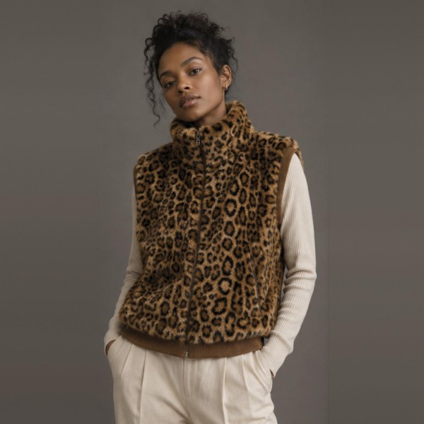 Leopard Print Sherpa Vest with a high stand collar, full zip front, and side pockets. The plush, cozy pile is finished with ribbed knit trim at the armholes and hem for a clean, structured fit. Layer it over a long sleeve tee, turtleneck, or sweater for an easy fall and winter look that works from weekend errands to holiday gatherings. Animal print and sherpa are two of the season's strongest sellers, and this vest puts both into one piece customers will reach for all season.