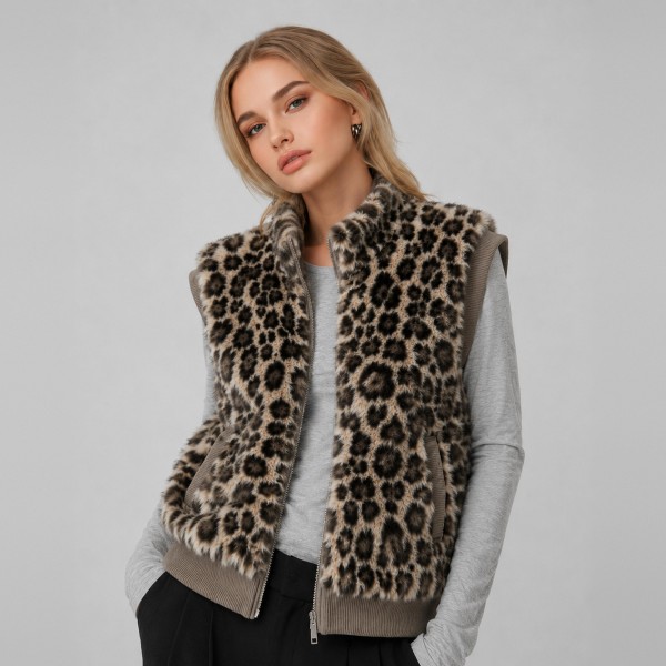 Leopard Print Sherpa Vest with a high stand collar, full zip front, and side pockets. The plush, cozy pile is finished with ribbed knit trim at the armholes and hem for a clean, structured fit. Layer it over a long sleeve tee, turtleneck, or sweater for an easy fall and winter look that works from weekend errands to holiday gatherings. Animal print and sherpa are two of the season's strongest sellers, and this vest puts both into one piece customers will reach for all season.