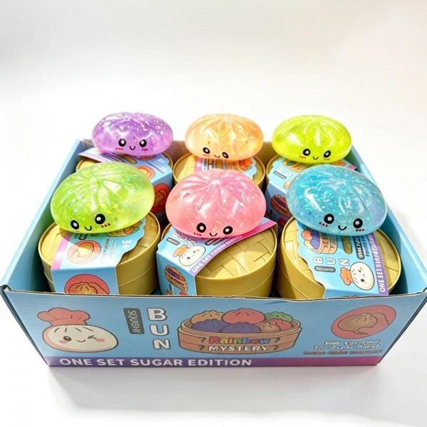Assorted glitter squishy bun toys packaged in mini steamer-basket gift boxes, sold as a 12-piece countertop display that merchandises itself. Each soft, slow-rise squishy has a smiling character face and a sparkly translucent finish kids love to stretch, squeeze, and collect. A proven impulse buy at the register for boutiques, gift shops, birthday favors, and classroom treats. Small footprint, fast turn, and an easy add-on that keeps kids happy while parents shop.