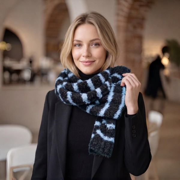 Striped fuzzy scarf in a soft eyelash boucle knit, a heavyweight winter scarf built for cold weather retail. Plush brushed yarn, wide contrast stripes, and a long wrap length that layers easily over coats, sweaters, and flannels. A go-to women's fashion scarf for fall and winter boutique displays, tailgates, farmers markets, and holiday gifting. Priced as an easy impulse add on, striped knit scarves reorder fast once temperatures drop.