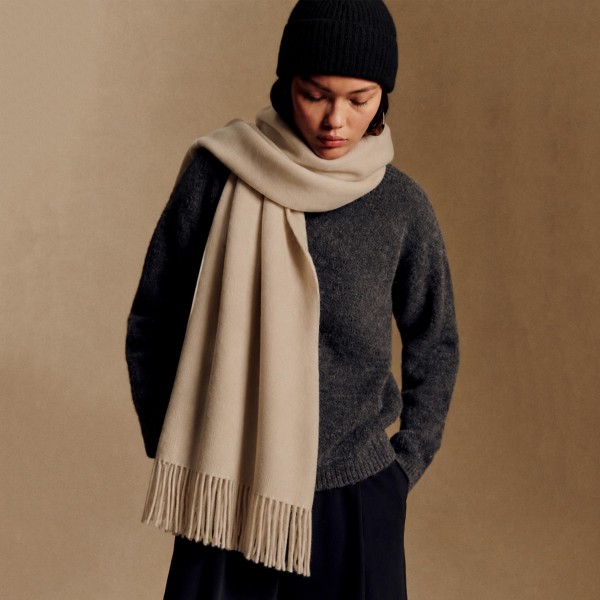 Solid Cashmere Feel Scarf in a soft, brushed blend of 83% polyester and 17% viscose. The oversized 70.9 x 27.6 inch size wraps easily around the neck or drapes over the shoulders like a shawl, finished with 3.9 inch fringe on each end. A warm, cozy layer for chilly days that pairs with coats, sweaters, and everyday outfits. Offered in a wide range of colors, this staple scarf is a must have for fall and winter displays.