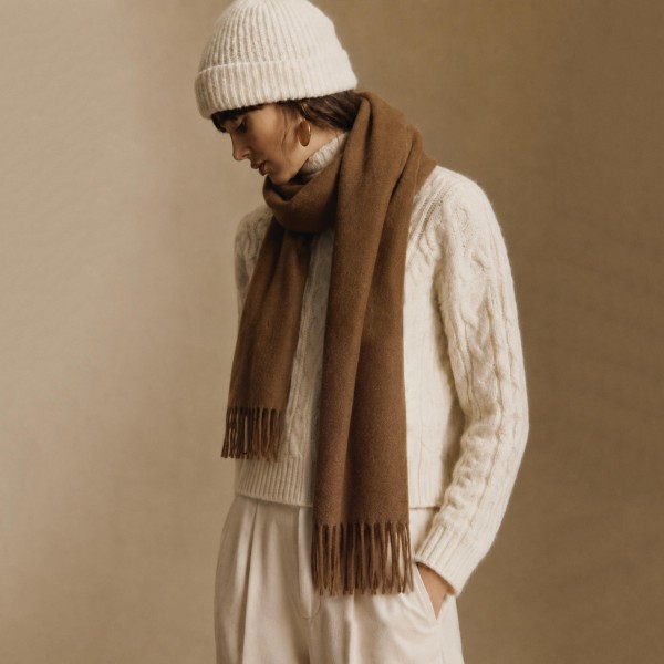 Solid Cashmere Feel Scarf in a soft, brushed blend of 83% polyester and 17% viscose. The oversized 70.9 x 27.6 inch size wraps easily around the neck or drapes over the shoulders like a shawl, finished with 3.9 inch fringe on each end. A warm, cozy layer for chilly days that pairs with coats, sweaters, and everyday outfits. Offered in a wide range of colors, this staple scarf is a must have for fall and winter displays.