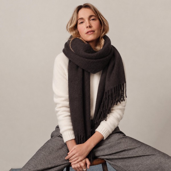 Solid Cashmere Feel Scarf in a soft, brushed blend of 83% polyester and 17% viscose. The oversized 70.9 x 27.6 inch size wraps easily around the neck or drapes over the shoulders like a shawl, finished with 3.9 inch fringe on each end. A warm, cozy layer for chilly days that pairs with coats, sweaters, and everyday outfits. Offered in a wide range of colors, this staple scarf is a must have for fall and winter displays.