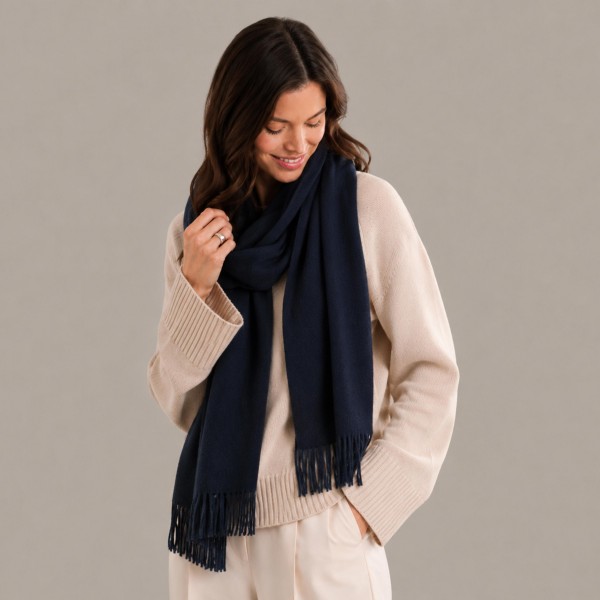 Solid Cashmere Feel Scarf in a soft, brushed blend of 83% polyester and 17% viscose. The oversized 70.9 x 27.6 inch size wraps easily around the neck or drapes over the shoulders like a shawl, finished with 3.9 inch fringe on each end. A warm, cozy layer for chilly days that pairs with coats, sweaters, and everyday outfits. Offered in a wide range of colors, this staple scarf is a must have for fall and winter displays.