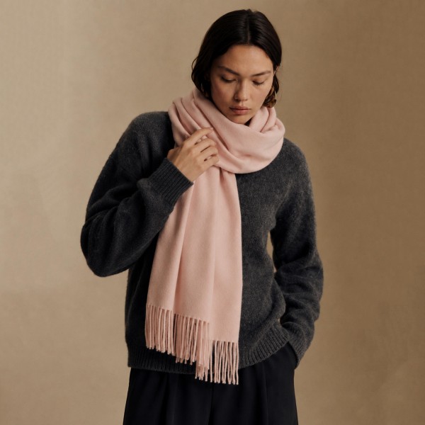 Solid Cashmere Feel Scarf in a soft, brushed blend of 83% polyester and 17% viscose. The oversized 70.9 x 27.6 inch size wraps easily around the neck or drapes over the shoulders like a shawl, finished with 3.9 inch fringe on each end. A warm, cozy layer for chilly days that pairs with coats, sweaters, and everyday outfits. Offered in a wide range of colors, this staple scarf is a must have for fall and winter displays.