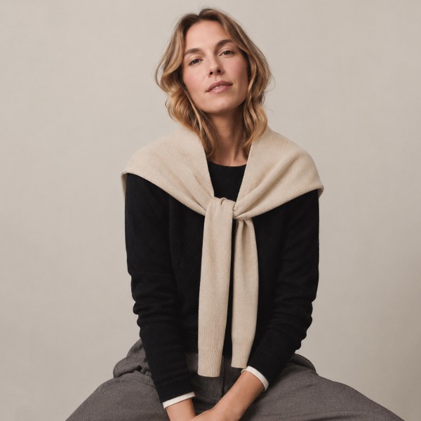 Knitted Shoulder Wrap in a soft blend of 30% cotton and 70% acrylic. Shaped to look like a sweater knotted over the shoulders, it delivers that effortless layered look in seconds. Toss it over a tee, button down, or dress for an instantly polished outfit. One size fits most, and the trend driven style makes it a standout seller for fall and winter.