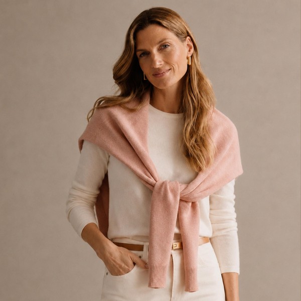 Knitted Shoulder Wrap in a soft blend of 30% cotton and 70% acrylic. Shaped to look like a sweater knotted over the shoulders, it delivers that effortless layered look in seconds. Toss it over a tee, button down, or dress for an instantly polished outfit. One size fits most, and the trend driven style makes it a standout seller for fall and winter.