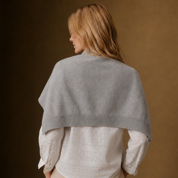Knitted Shoulder Wrap in a soft blend of 30% cotton and 70% acrylic. Shaped to look like a sweater knotted over the shoulders, it delivers that effortless layered look in seconds. Toss it over a tee, button down, or dress for an instantly polished outfit. One size fits most, and the trend driven style makes it a standout seller for fall and winter.