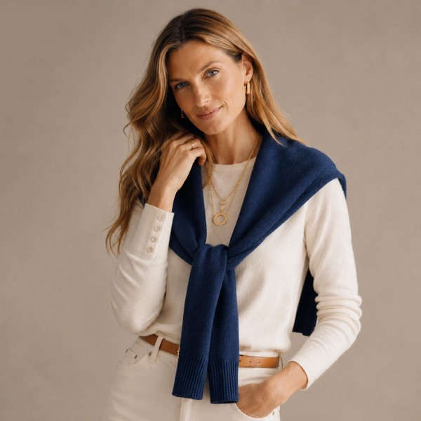 Knitted Shoulder Wrap in a soft blend of 30% cotton and 70% acrylic. Shaped to look like a sweater knotted over the shoulders, it delivers that effortless layered look in seconds. Toss it over a tee, button down, or dress for an instantly polished outfit. One size fits most, and the trend driven style makes it a standout seller for fall and winter.