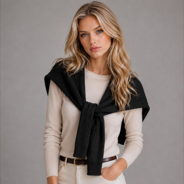 Cable Knit Sweater Shoulder Wrap that recreates the classic sweater over the shoulders look without the bulk of a full pullover. Soft cable knit sleeves tie loosely at the chest for an effortless, preppy finish over button downs, tees, and dresses. Perfect for cool fall mornings, country club brunches, football tailgates, and travel days. This trending layering piece is a quick seller that boutique shoppers love to style and gift.