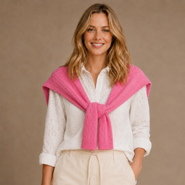Cable Knit Sweater Shoulder Wrap that recreates the classic sweater over the shoulders look without the bulk of a full pullover. Soft cable knit sleeves tie loosely at the chest for an effortless, preppy finish over button downs, tees, and dresses. Perfect for cool fall mornings, country club brunches, football tailgates, and travel days. This trending layering piece is a quick seller that boutique shoppers love to style and gift.