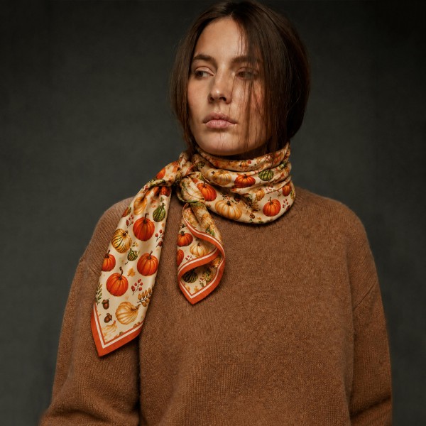 Pumpkin Patch Silky Square Scarf with an allover harvest print of heirloom pumpkins, gourds, and autumn berries framed by a bright border. The smooth satin feel ties as a neckerchief, drapes over a sweater, or wraps a ponytail or purse handle. Ideal for pumpkin patch trips, fall festivals, Halloween parties, and Thanksgiving gatherings. Pumpkin prints are a fall favorite that sell all season long and make a sweet hostess or teacher gift.