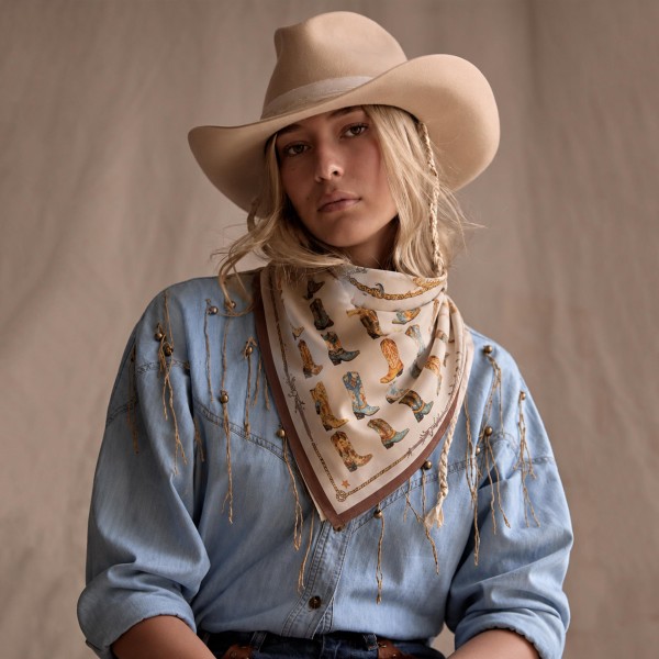 Cowboy Boot Print Silky Square Scarf with rows of western boots and a lasso inspired border for a playful country look. Wear it as a neckerchief, tie it around a hat, or knot it onto a bag strap for easy western flair. A natural fit for rodeos, country concerts, bachelorette weekends, and fall festivals. Cowgirl style keeps trending, and boot print scarves are an affordable impulse buy that pairs perfectly with denim and hats.