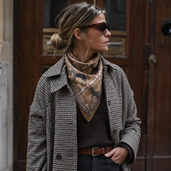 Equestrian print square scarf in a lightweight satin-feel woven, finished with a horse and bridle motif framed by a chain-link border. The generous square knots easily at the neck, ties into a ponytail or low bun, and loops onto a handbag handle for an instant refresh. Riding-inspired prints read polished with a blazer and relaxed with denim, making this a true transitional piece for fall. An easy impulse add-on that keeps the accessory wall turning.
