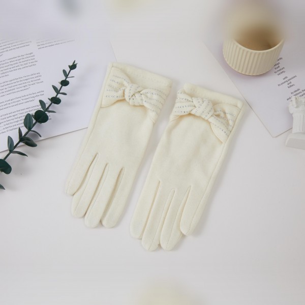 Bow Accent Gloves with a soft brushed finish and a sweet decorative bow at each wrist for a feminine, polished look. The fitted five finger silhouette keeps hands warm and pairs beautifully with wool coats and dressy winter outfits. Lovely for holiday parties, church, date nights, and everyday errands. Pretty bow gloves make a thoughtful gift and are an easy add on sale in any cold weather accessory display.