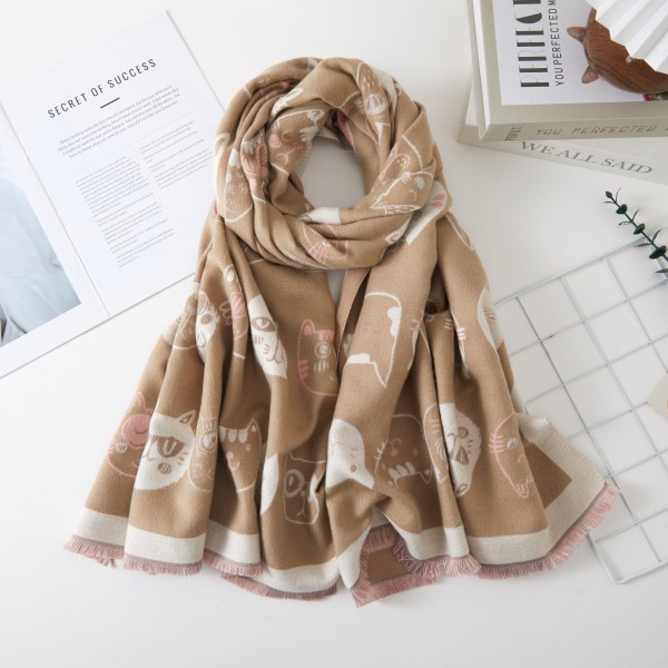 Cat Print Scarf with whimsical kitty faces scattered across a soft, cozy weave and finished with a contrast border and fringe trim. This long oblong wrap drapes, loops, or knots easily for warmth on chilly days. A sweet gift for cat lovers, teachers, and pet moms who love a playful accessory. Novelty print scarves are a fun conversation starter that sells quickly all fall and winter.