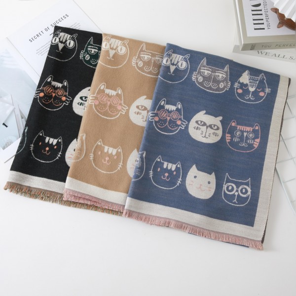 Cat Print Scarf with whimsical kitty faces scattered across a soft, cozy weave and finished with a contrast border and fringe trim. This long oblong wrap drapes, loops, or knots easily for warmth on chilly days. A sweet gift for cat lovers, teachers, and pet moms who love a playful accessory. Novelty print scarves are a fun conversation starter that sells quickly all fall and winter.