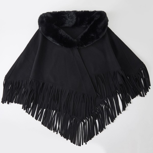 Faux Fur Collar Fringe Poncho in a soft, brushed fabric with a plush fur trimmed neckline and swingy fringe along the hem. The relaxed, open drape layers easily over sweaters, tees, and dresses for effortless warmth. Cozy enough for chilly mornings and polished enough for holiday gatherings and weekend outings. Ponchos are a dependable fall and winter seller, and the fur collar gives this style a fresh, giftable upgrade.