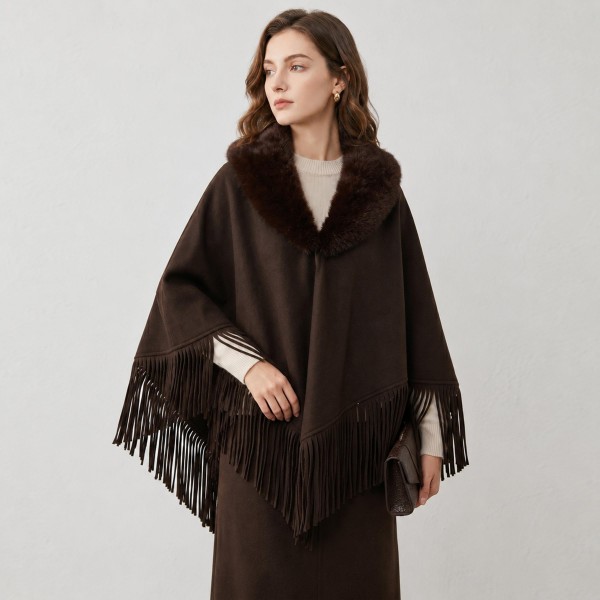 Faux Fur Collar Fringe Poncho in a soft, brushed fabric with a plush fur trimmed neckline and swingy fringe along the hem. The relaxed, open drape layers easily over sweaters, tees, and dresses for effortless warmth. Cozy enough for chilly mornings and polished enough for holiday gatherings and weekend outings. Ponchos are a dependable fall and winter seller, and the fur collar gives this style a fresh, giftable upgrade.