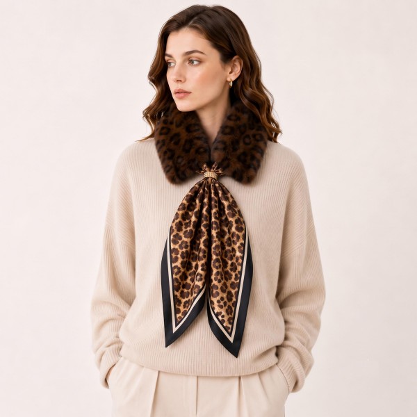 Faux Fur Collar Scarf with an attached leopard print satin tie and a decorative brooch at the center. The plush collar frames the neckline while the silky tails add movement and polish over sweaters, coats, and dresses. An easy way to elevate a simple fall outfit for the office, date night, or holiday parties. Faux fur and leopard are two of the season's top trends, and this piece pairs both in one quick selling accessory.