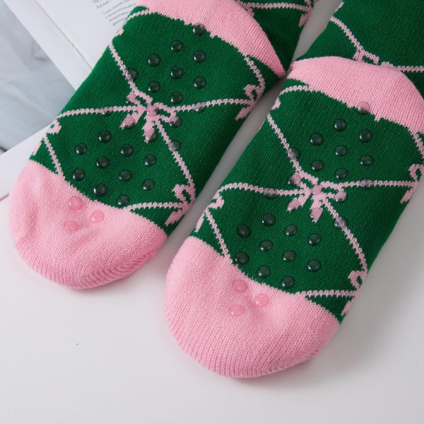 Bow and Checkered Sherpa Slipper Socks in two trend right prints, a dainty bow lattice and a bold checkerboard, finished with a fluffy sherpa cuff. The plush lining feels like a warm hug for feet during lazy weekends, holiday travel, and chilly nights at home. Packed as an assortment of both designs. Bows and checks are two of the most wanted motifs this season, making these an easy gift and a cute impulse add near the register.