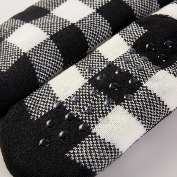 Buffalo Check Christmas Fuzzy Socks with a classic check pattern and playful holiday character toppers at the ankle. Ultra soft plush knit feels like a warm hug for cold toes, perfect for lounging, holiday movie nights, and Christmas morning. Sold in an assorted pack of festive designs, they make an easy stocking stuffer, gift exchange pick, or add on at checkout. Cozy socks are a year end bestseller that keeps boutique registers busy all season.