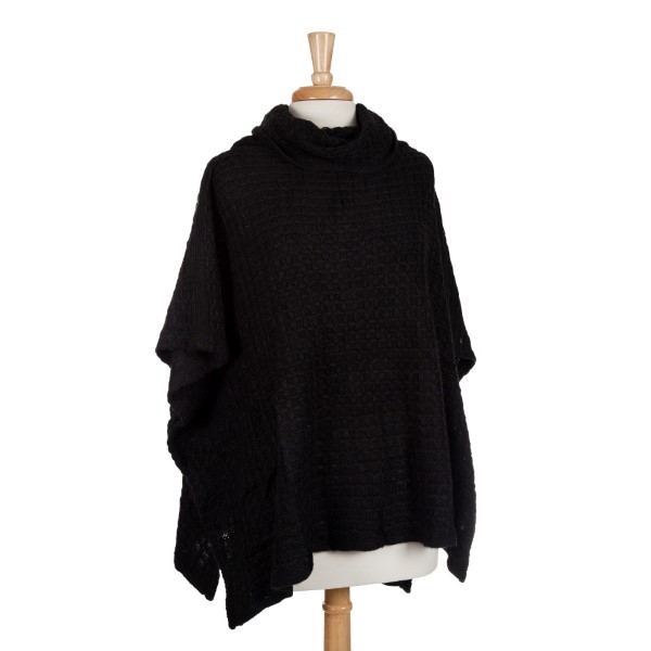 Black short sleeve, turtle neck poncho top with a cable knit pattern. 100% acrylic. One size fits most. 