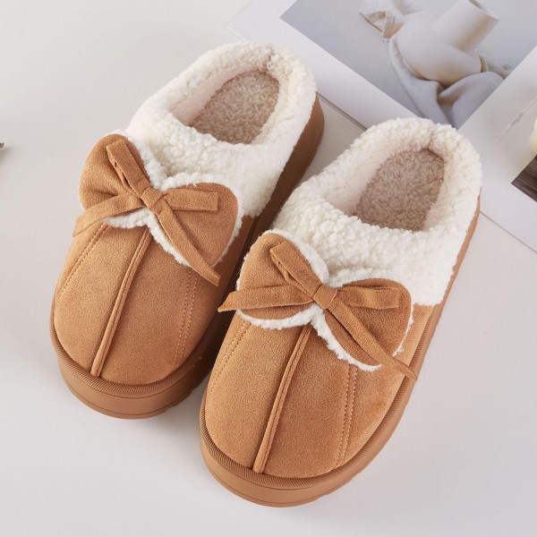 Faux Suede Bow Slippers with a plush sherpa lining, a fluffy folded cuff, and a sweet tied bow across the toe. The cushioned platform sole adds a little lift and keeps feet comfortable on hard floors, while the closed toe shape holds in warmth on chilly mornings. Packed as an assortment of sizes. Bow details are one of the most requested cozy looks this season, making these slippers an easy gift and a fast seller from fall straight through the holidays.
