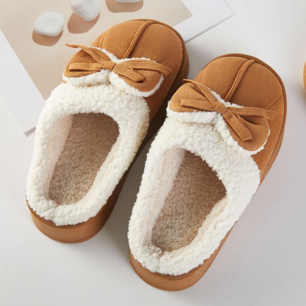Faux Suede Bow Slippers with a plush sherpa lining, a fluffy folded cuff, and a sweet tied bow across the toe. The cushioned platform sole adds a little lift and keeps feet comfortable on hard floors, while the closed toe shape holds in warmth on chilly mornings. Packed as an assortment of sizes. Bow details are one of the most requested cozy looks this season, making these slippers an easy gift and a fast seller from fall straight through the holidays.